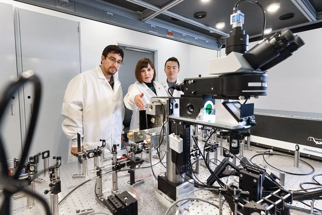 A professor and students work in a lab